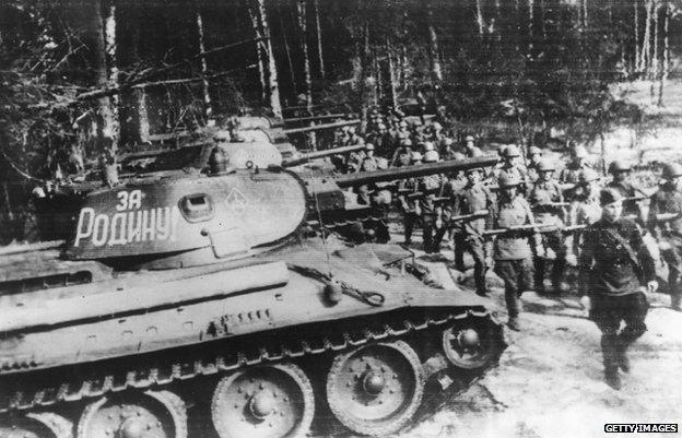 Russian soldiers march past the T-34 tank in 1943