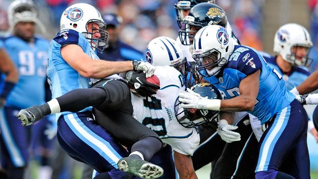 One NFL player is lifted and tackled by the opposition