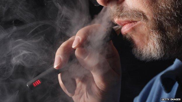 A man vaping on an electronic cigarette