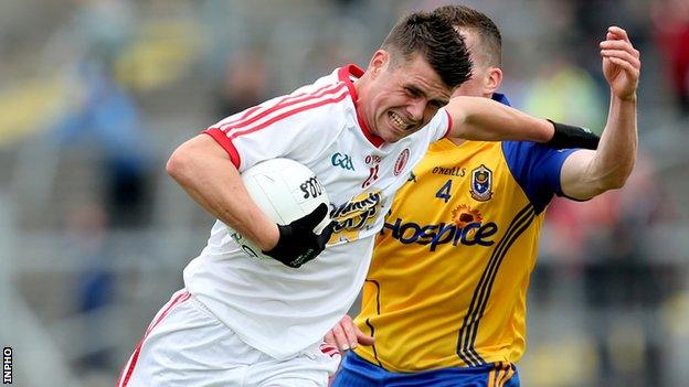 Tyrone's Darren McCurry tries to fend off Roscommon's Seanie McDermott