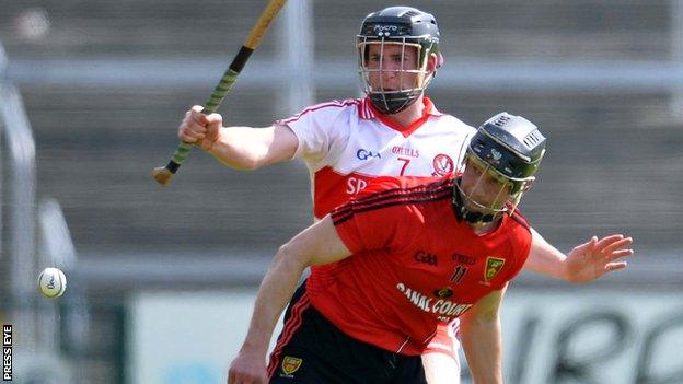 Paul Braniff battles with Malachy O'Hagan in the Ulster hurling semi-final replay