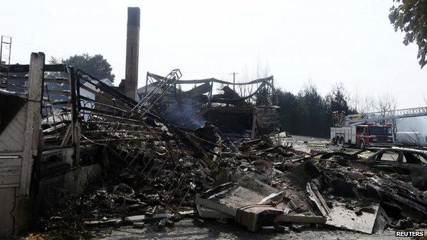 Burned-out buildings are seen near the wreckage of the train derailment in Lac-Megantic, 7 July 2013