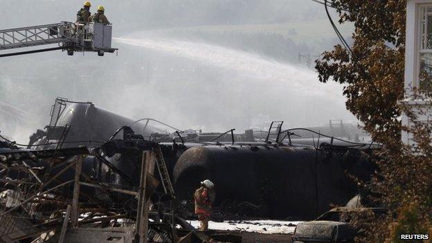 Firefighters work at the scene of the train derailment in Lac-Megantic, Canada, 7 July 2013