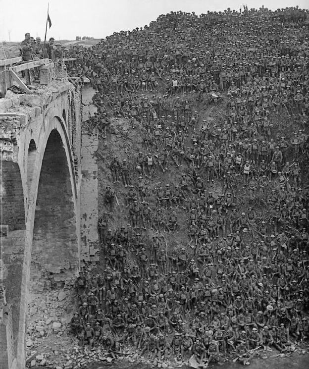 Troops en masse are sat on a big hill next to Riqueval Bridge