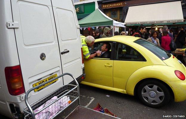 Man speaking to another in a car