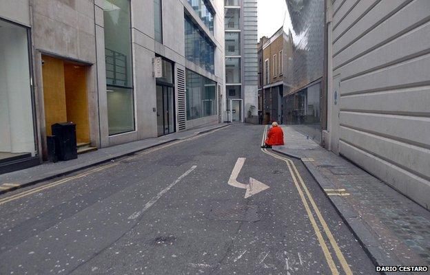 Woman in red sitting on street