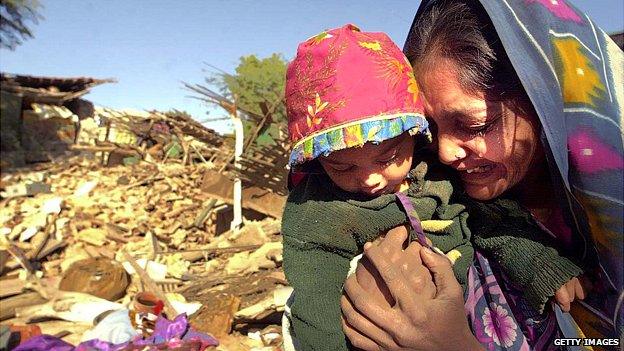 Woman cries in front of her destroyed home in Bhuj, western India