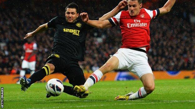 Antolin Alcaraz (left) in action against Arsenal