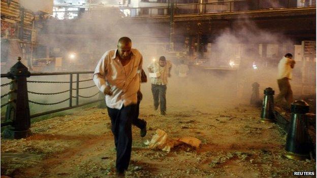 Protesters run from tear gas near 6 October bridge in Cairo (15 July 2013)