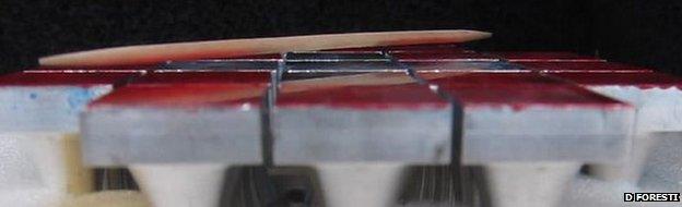 Toothpick being acoustically levitated