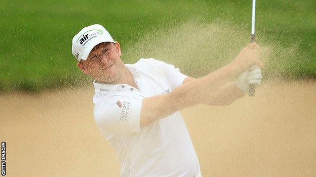 Jamie Donaldson sends the sand flying as he plays out of a bunker