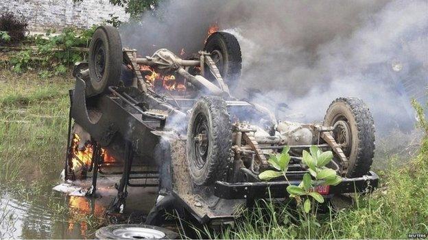 An overturned police jeep on fire and set ablaze by protesters in Chhapra in the the state of Bihar on 17 July 2013