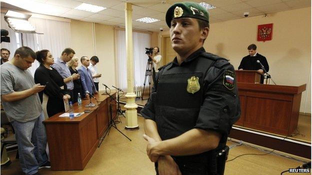 Russian protest leader Alexei Navalny (4th L) attends a court hearing in Kirov, July 18, 2013, as Judge Sergei Blinov gives his verdict