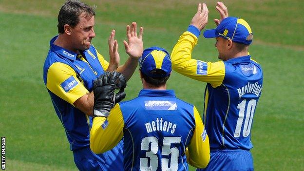 Rikki Clarke takes a wicket for Warwickshire