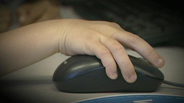 A child using a computer mouse