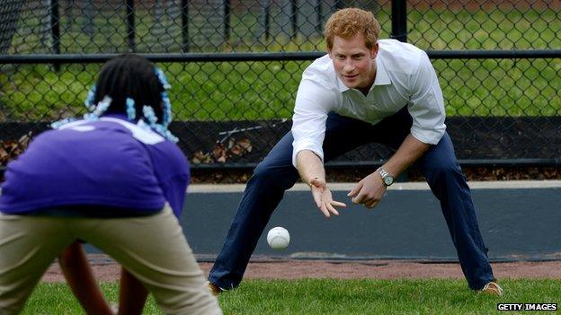 Prince Harry plays catch with a youngster