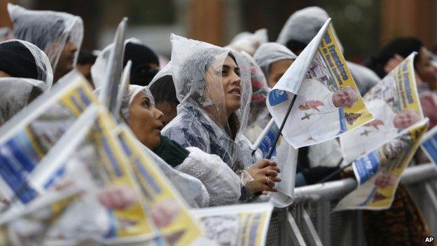 Pilgrims wait for the arrival of Pope Francis outside the Aparecida Basilica