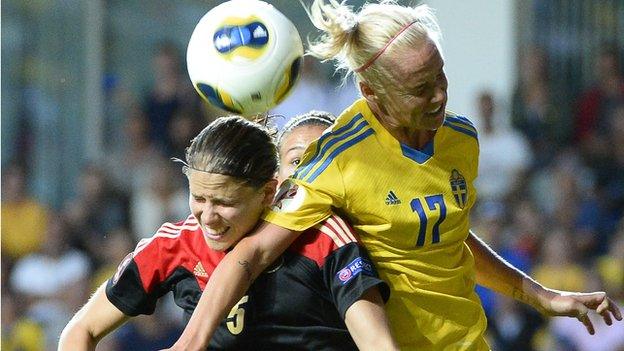 German and Swedish players Annike Krahn and Caroline Seger fight for the ball