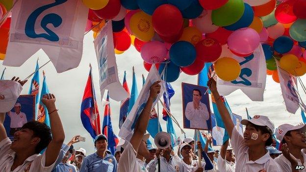 Supporters prepare to release balloons during a pre-election rally for the ruling Cambodian People's Party on 26 July 2013 in Phnom Penh, Cambodia