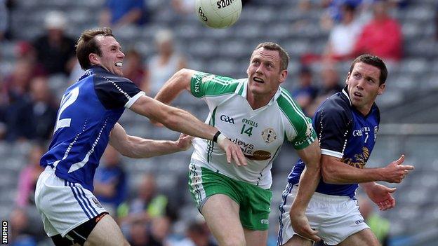 Lorcan Mulvey of London in against Cavan opponents Feargal Flanagan and Ronan Flanagan