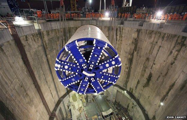 A tunnel-boring machine is lowered through a shaft on the London Crossrail site