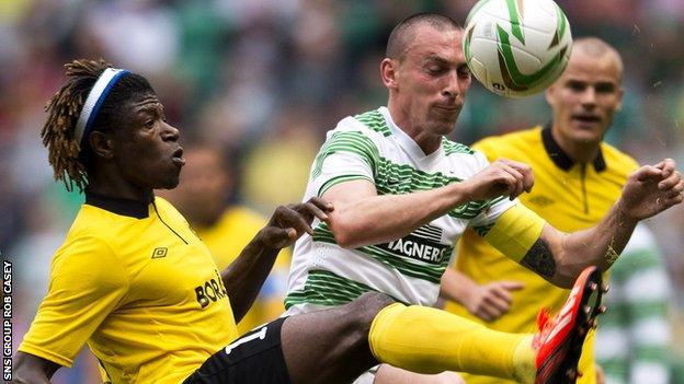 Scott Brown challenges Mo Bagura at Celtic Park