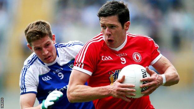 Sean Cavanagh tries to burst away from Darren Hughes at Croke Park