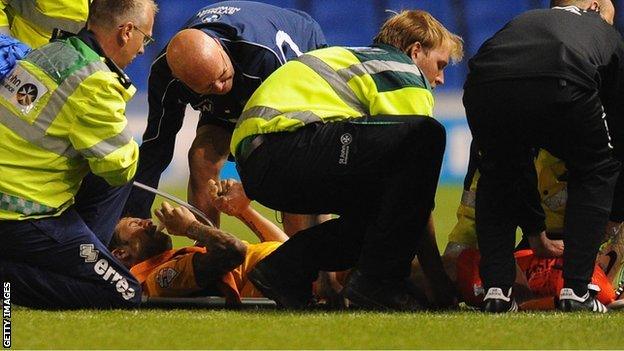 Byron Anthony receives treatment on the pitch at Brighton