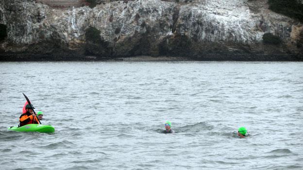 Three swimmers - Gavin and his children - and Mark in the kayak