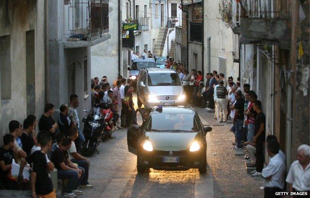 A funeral cortege passes through San Luca, Calabria