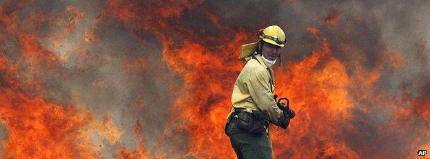 Firefighter tackling a wildfire in Spain (Image: AP)