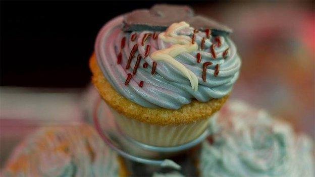 Grey cupcake decorated with rainclouds