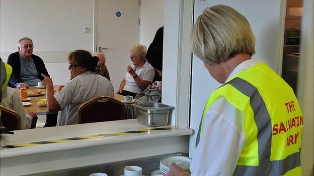 Salvation Army volunteers provide tea and toast for residents