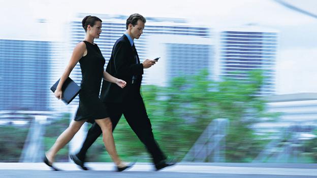 A businessman and businesswoman walking