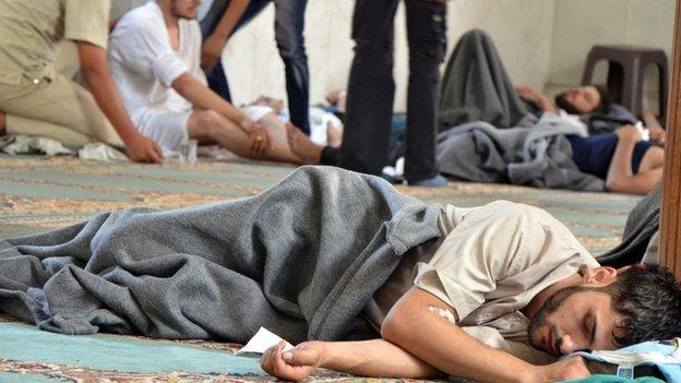 A man, who Syrian opposition activists say survived a chemical weapon attack, rests in a mosque in Douma, Damascus (21 August 2013)