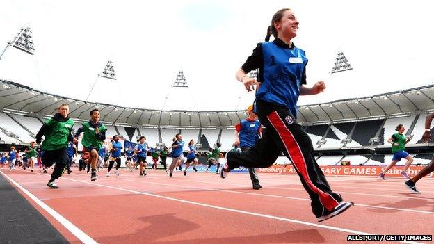 children running in Olympic stadium