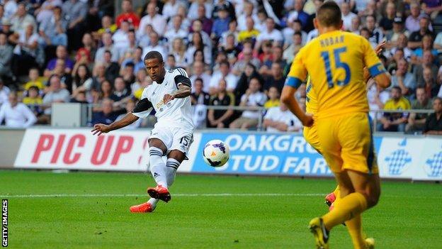 Swansea player Wayne Routledge scores the opening goal