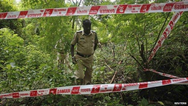 Policemen on 23 August 2013 survey the crime scene where a photojournalist was raped inside an abandoned textile mill in Mumbai