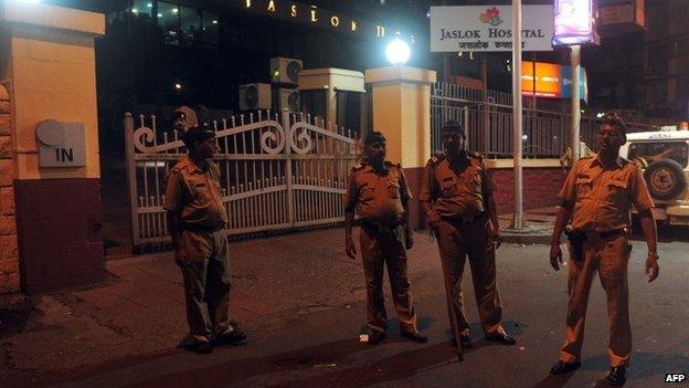 Policemen stand at the entrance gate to the city hospital where the gang rape victim is admitted, in Mumbai early morning on August 23, 2013