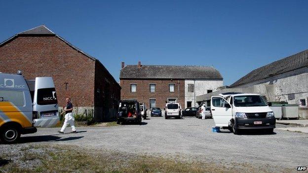 Police officers conduct searches as part of a major drug investigation, on August 23, 2013, in Chimay.