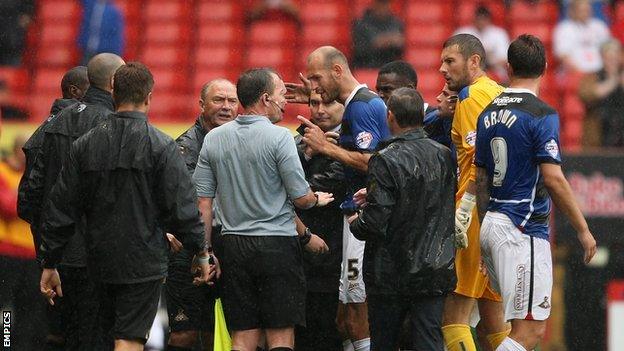 Doncaster's player argue with referee Lee Collins as their game with Charlton is abandoned