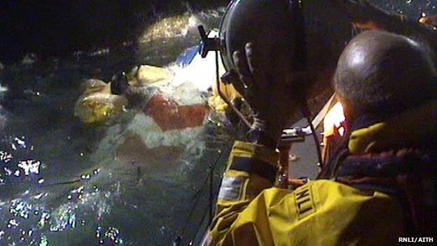 RNLI volunteers inspect the helicopter wreckage