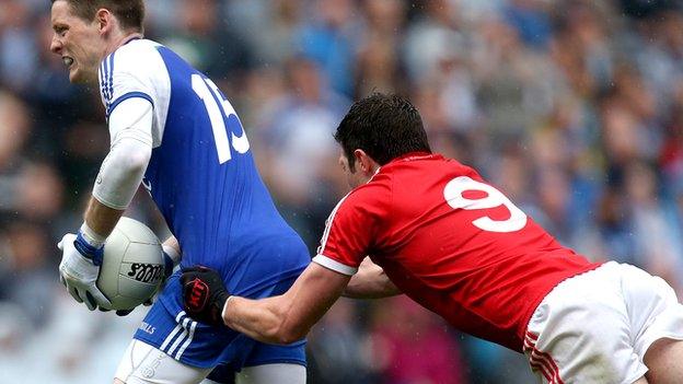 Monaghan's Conor McManus is tackled by Sean Cavanagh of Tyrone