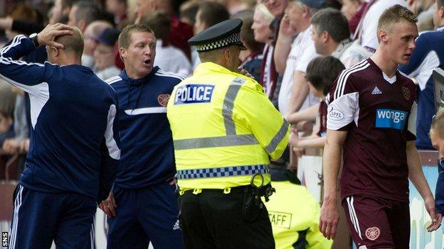 Gary Locke watches Kevin McHattie leave the field