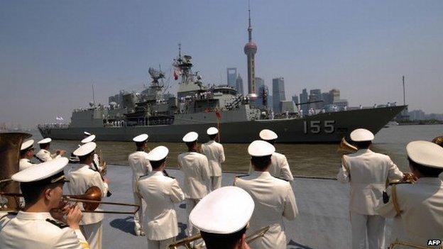 A Chinese navy band welcomes Australian frigate HMAS Ballarat as she arrives in Shanghai on 17 May 2012