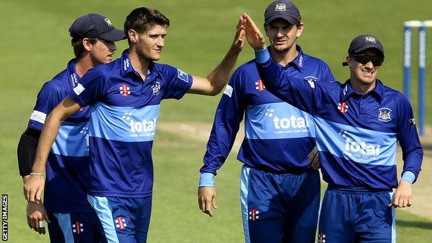 Gloucestershire team celebrate taking a wicket