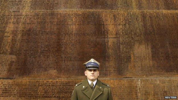 Soldier at memorial to the Katyn Massacre victims