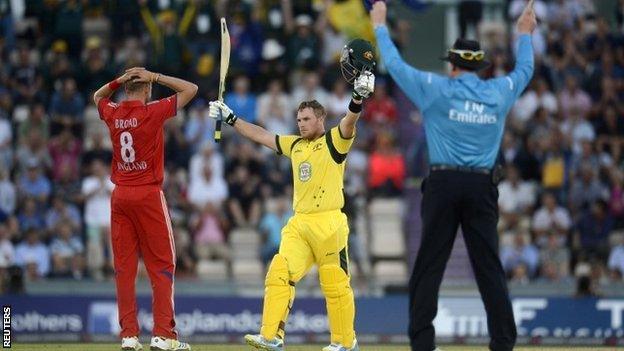 Australia's Aaron Finch (centre) celebrates bringing up his century as the umpire signals six and England bowler Stuart Broad reacts