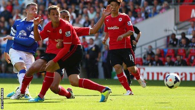 Everton’s Ross Barkley shoots past Cardiff’s Ben Turner and Steven Caulker