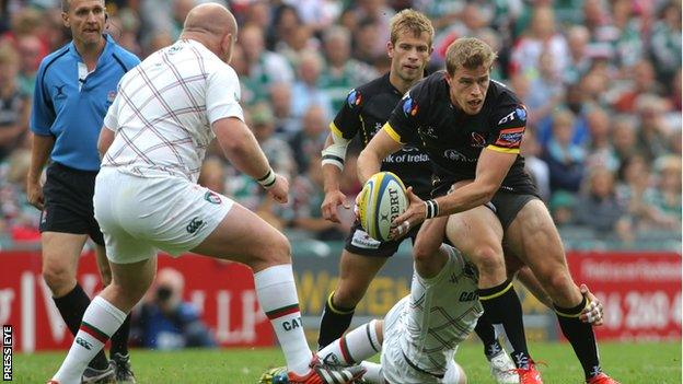 Andrew Trimble tries to break away from a Tom Croft tackle as Dan Cole looms for the Ulster winger